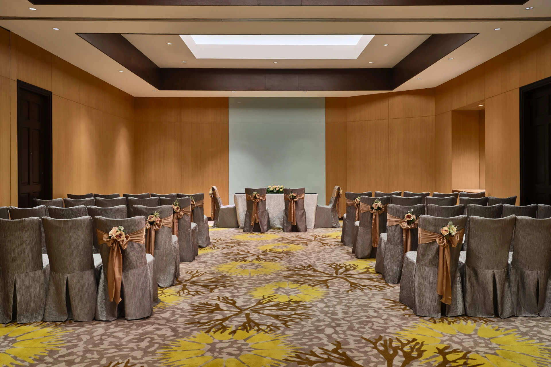 Paradox Singapore Rosewood Room theatre-style ceremony setup with velvet chairs and frosted glass wall