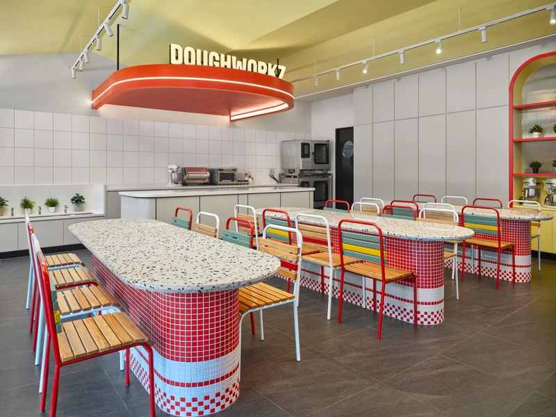 Doughworkz prep kitchen with communal tables and red oval pendant at PastaMania Sengkang