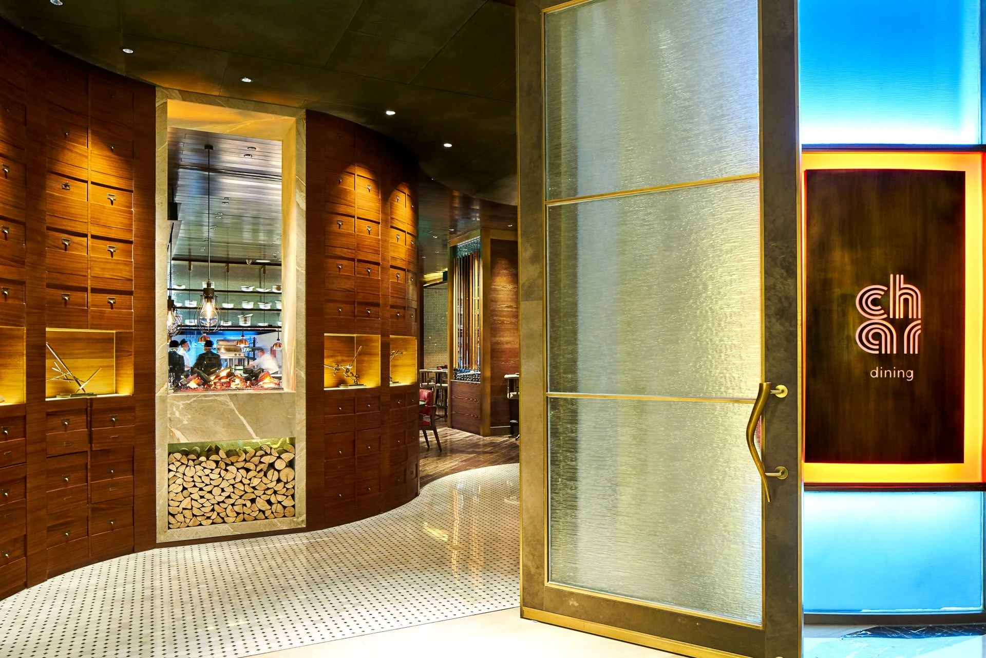 Walnut corridor with open kitchen window and stacked firewood