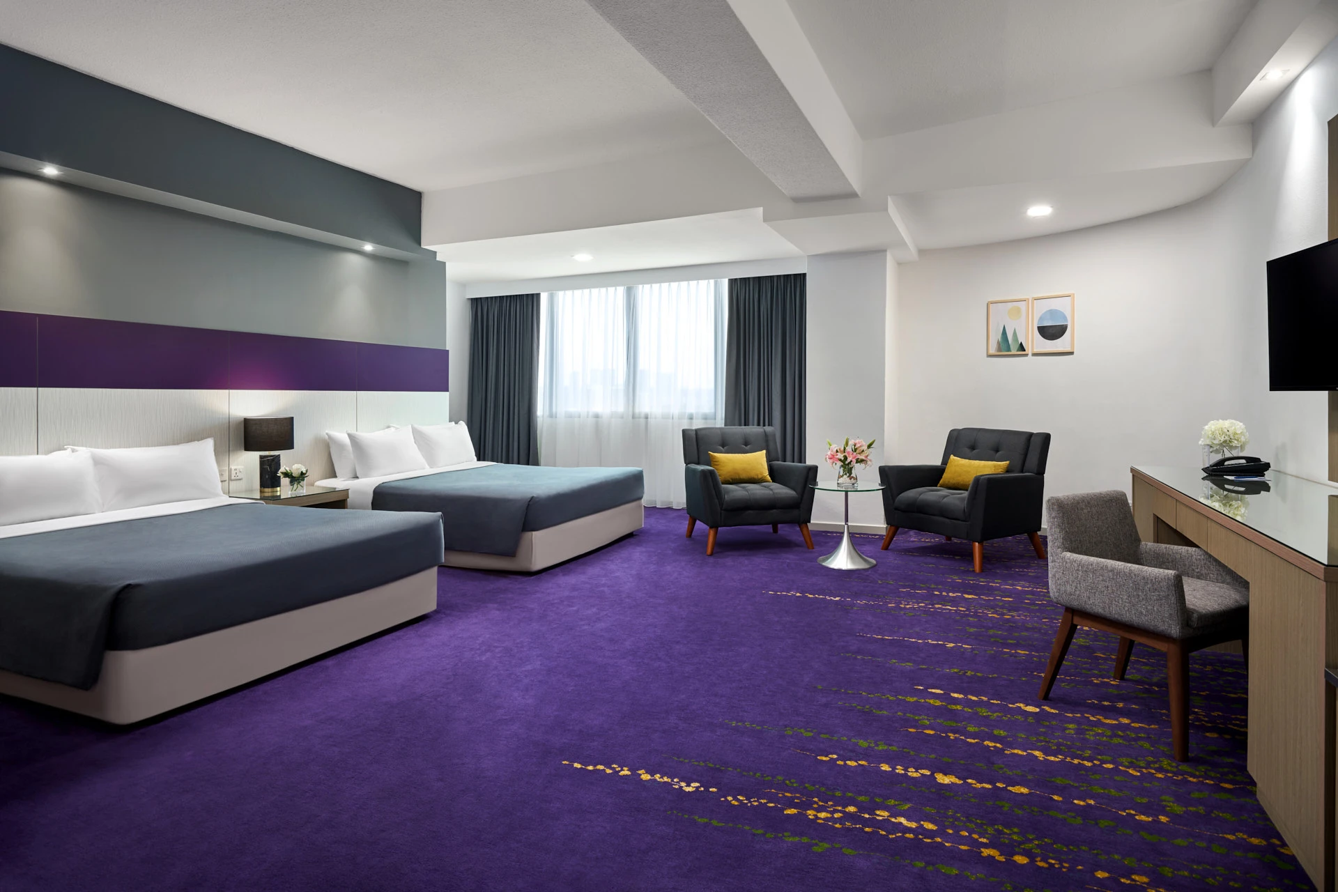Twin room with purple carpet, striped feature wall and mustard cushions