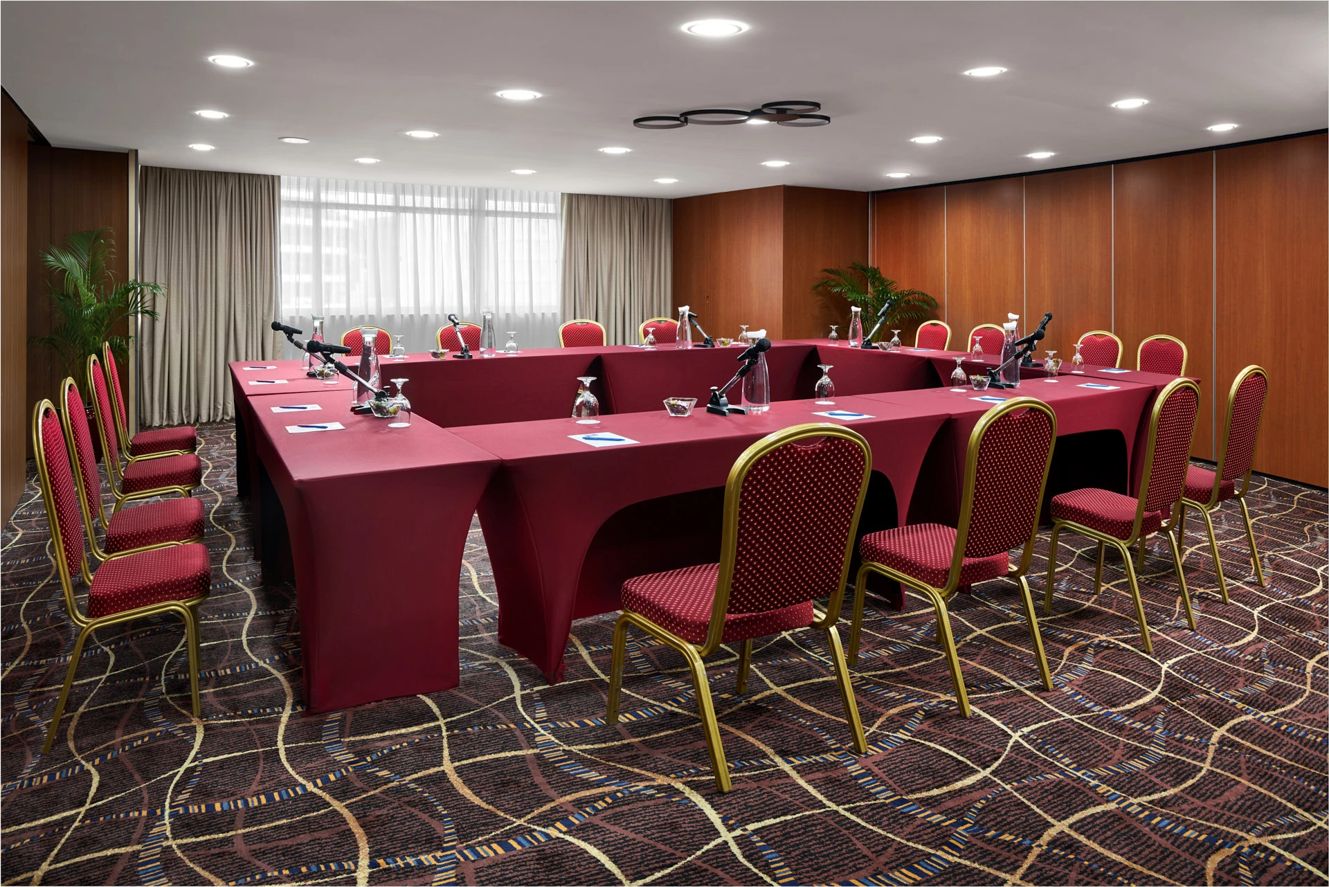 U-shape meeting with gooseneck microphones and wooden wall panels — RELC Hotel Singapore function room photography