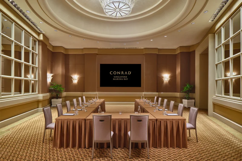 Conrad Singapore Marina Bay Grand Salon in U-shape setup with curved ceiling detail, warm wall panels and banquet seating