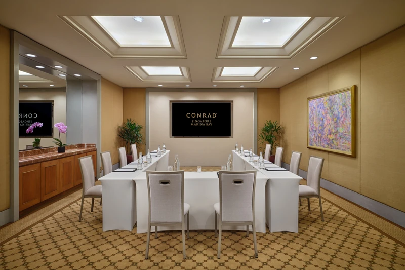 Conrad Singapore Marina Bay Salon 2 in U-shape setup with intimate meeting room seating and soft hotel lighting