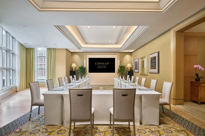 Conrad Singapore Marina Bay Salon 4 in U-shape setup with intimate meeting room seating and soft hotel lighting