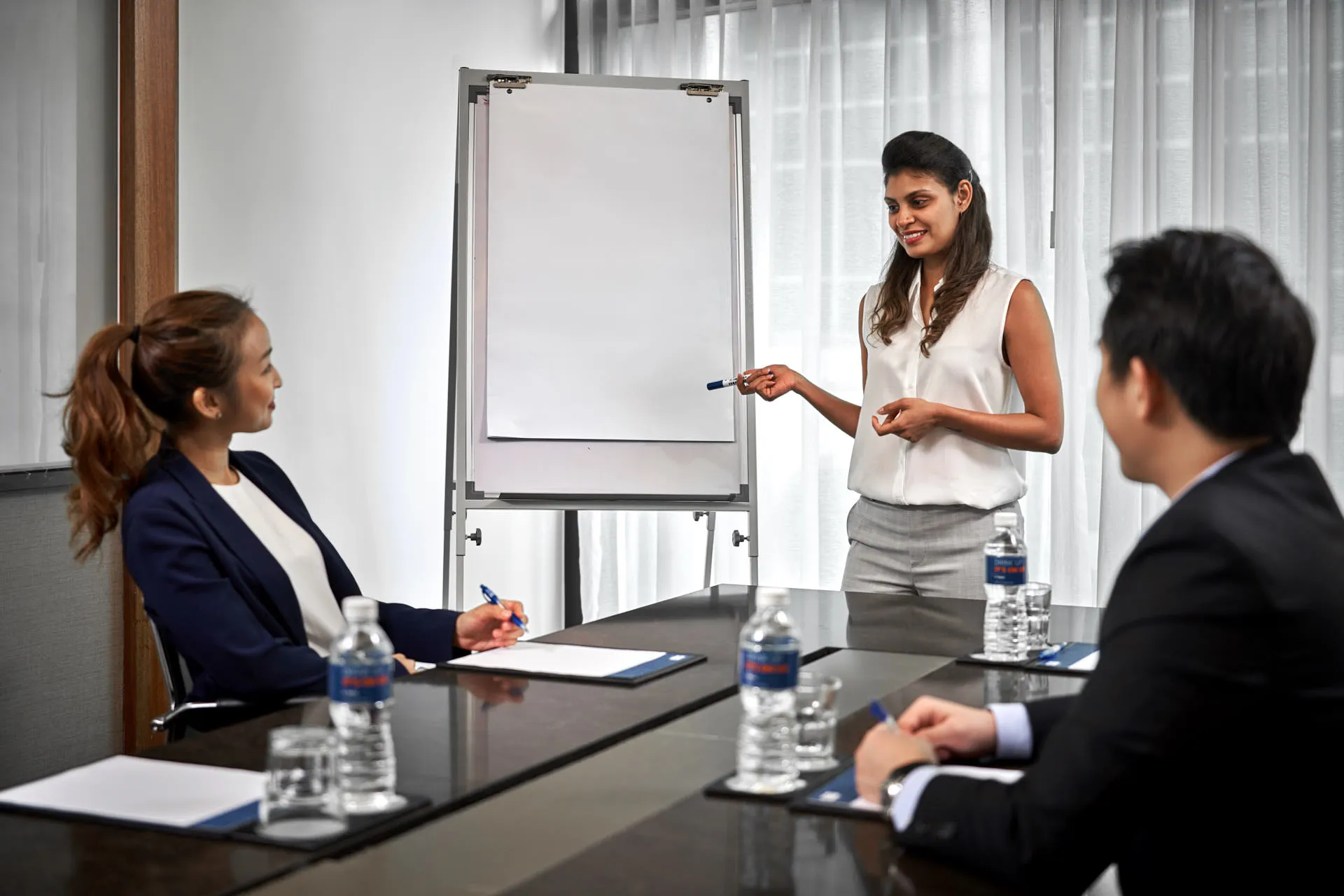 Team presenting at whiteboard in hotel meeting room — Holiday Inn Express Clark Quay hospitality photography