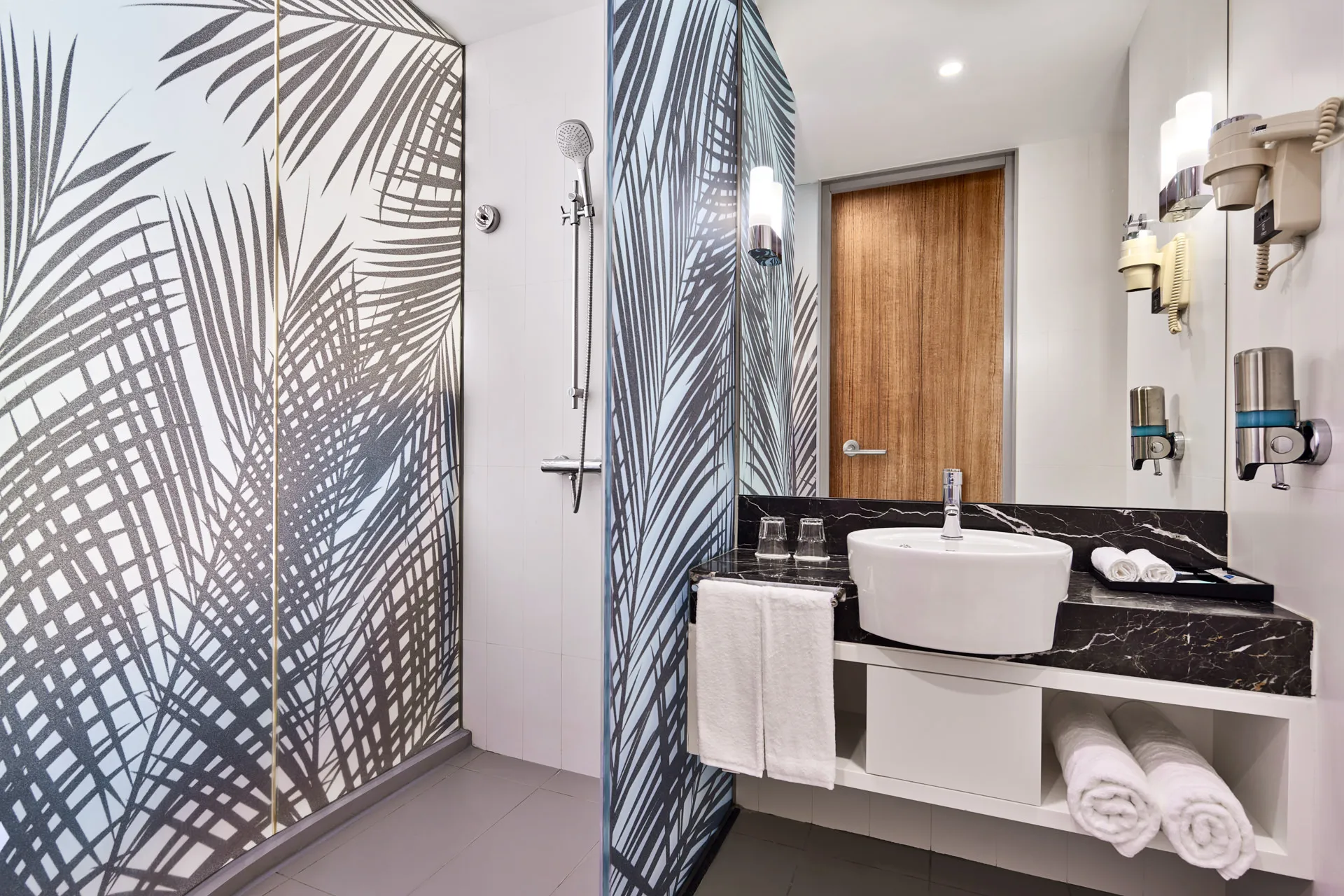 Modern bathroom with rain shower, palm-print glass and vessel sink — Holiday Inn Express Orchard hotel photography
