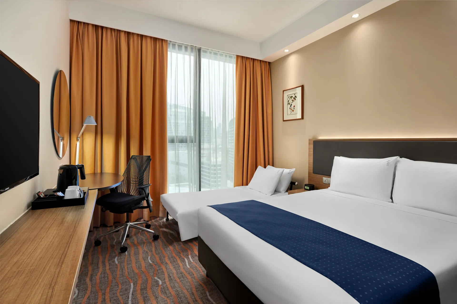 Twin room with navy runners, work desk and amber curtains — Holiday Inn Express Orchard hotel photography