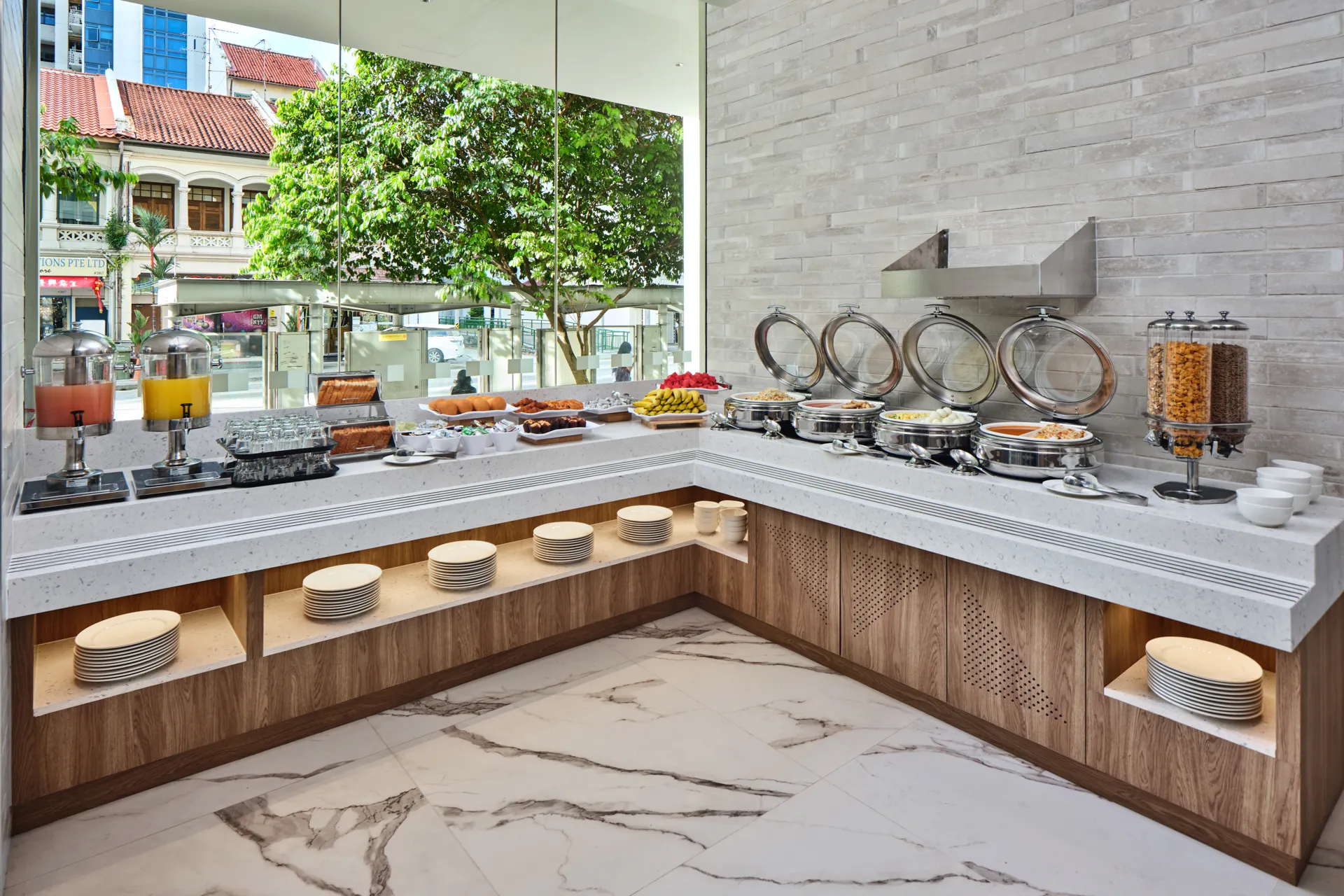 Breakfast buffet with chafing dishes and shophouse street views — Holiday Inn Express Serangoon hospitality photography