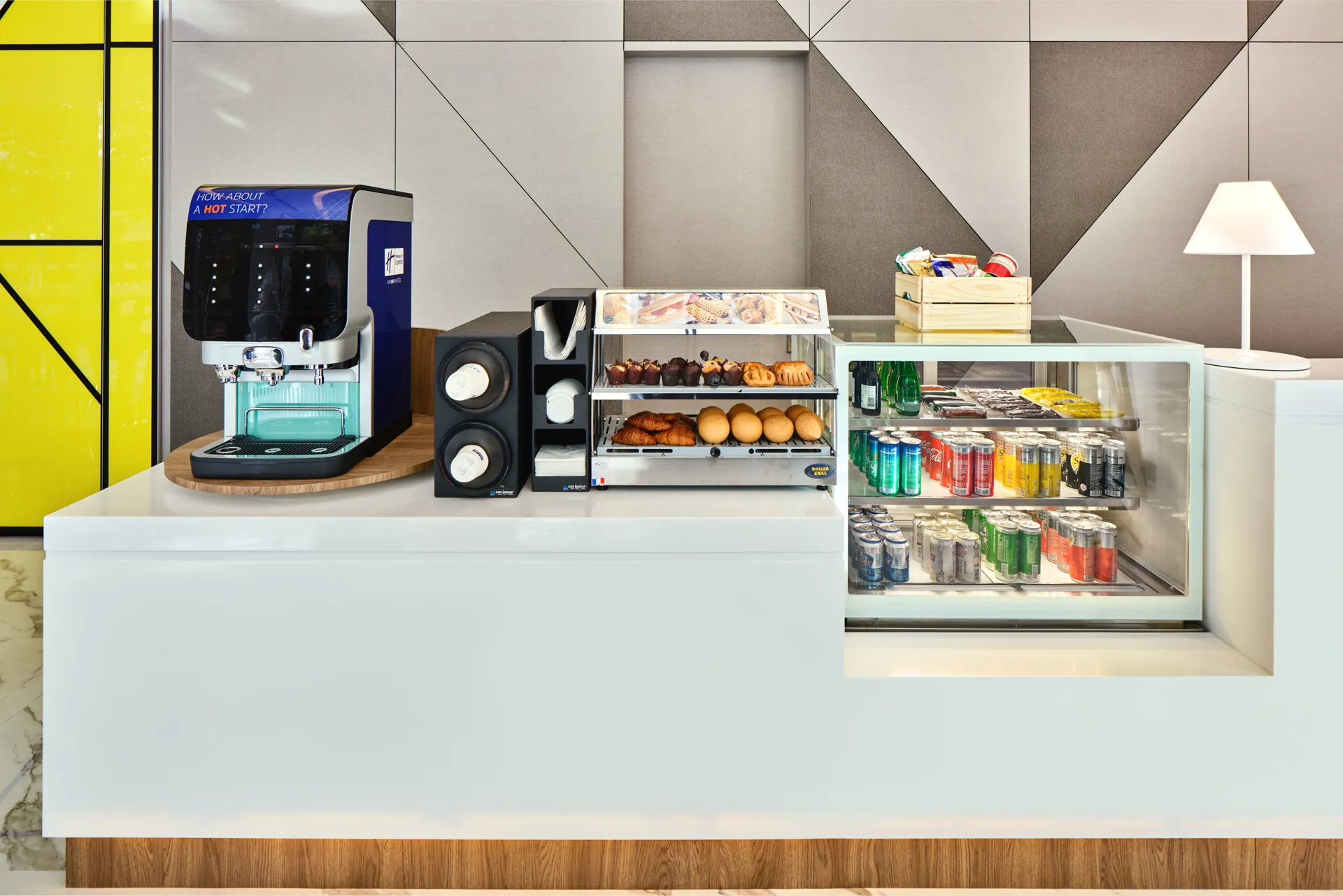 Grab-and-go station with coffee machine and pastry display — Holiday Inn Express Serangoon hotel photography