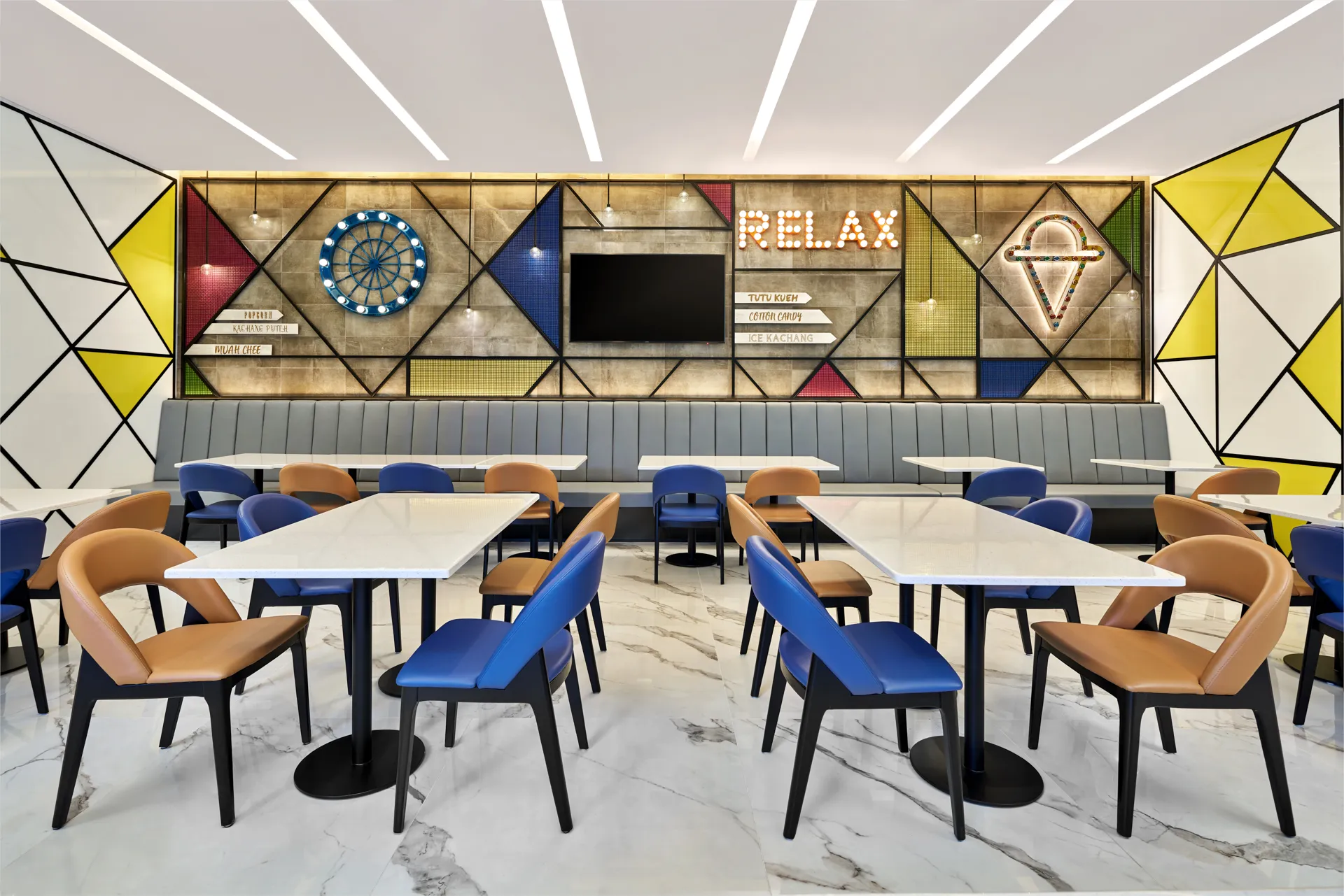 Dining lounge with carnival feature wall, neon signage and banquette seating — Holiday Inn Express Serangoon interior photography