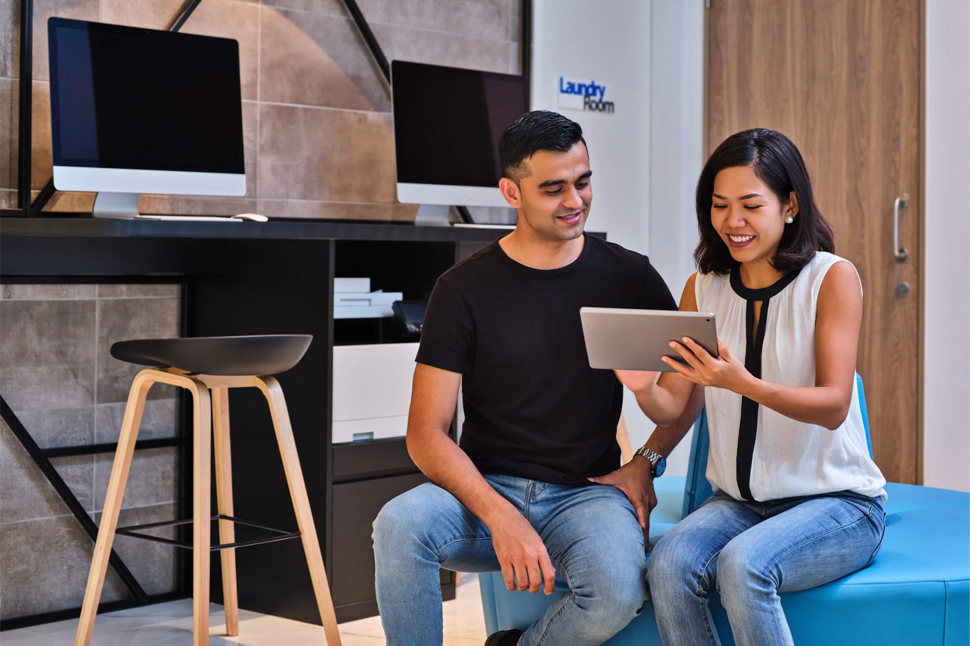 Couple browsing tablet in hotel business lounge