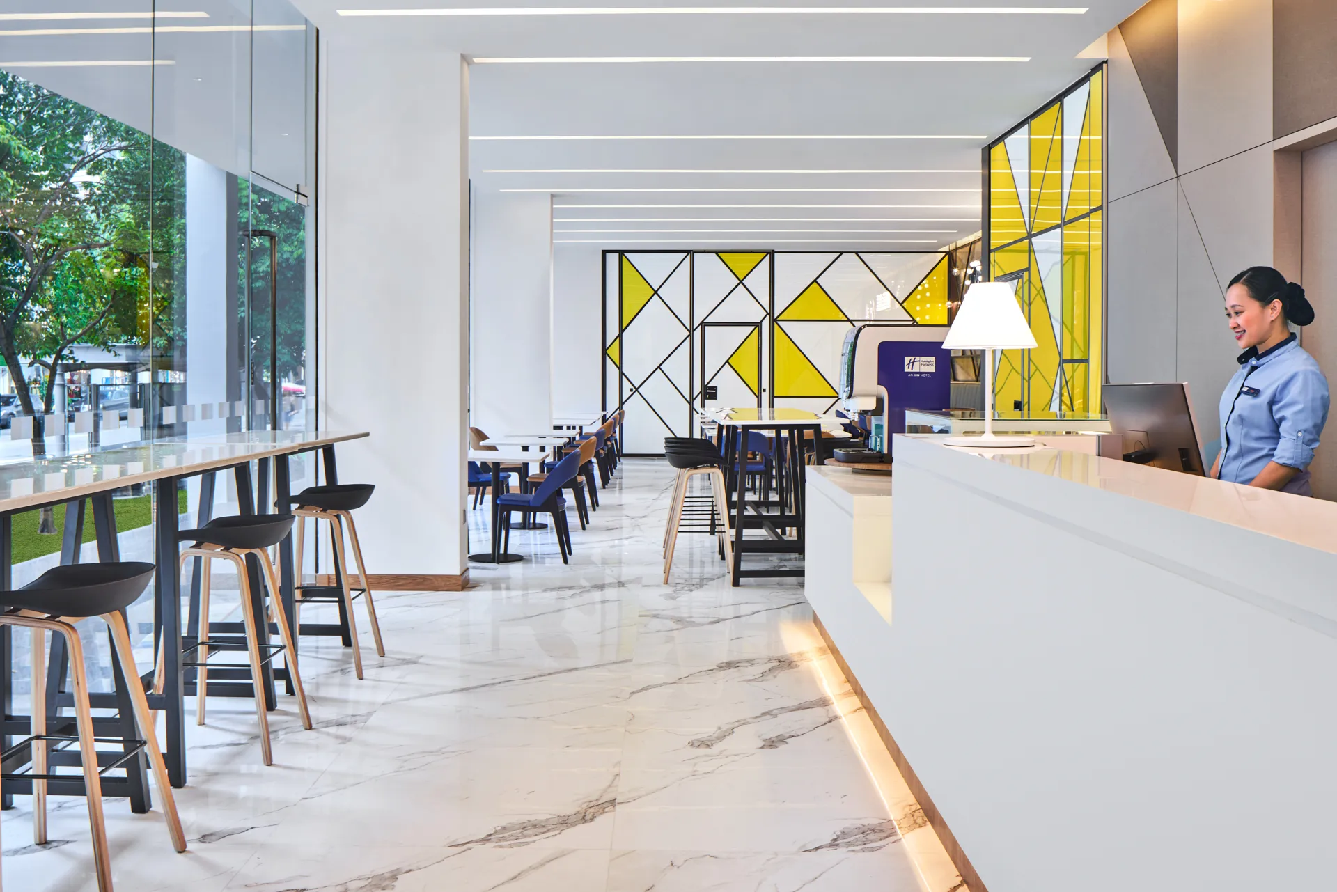 Open-plan lobby connecting reception to dining with natural light — Holiday Inn Express Serangoon hotel photography