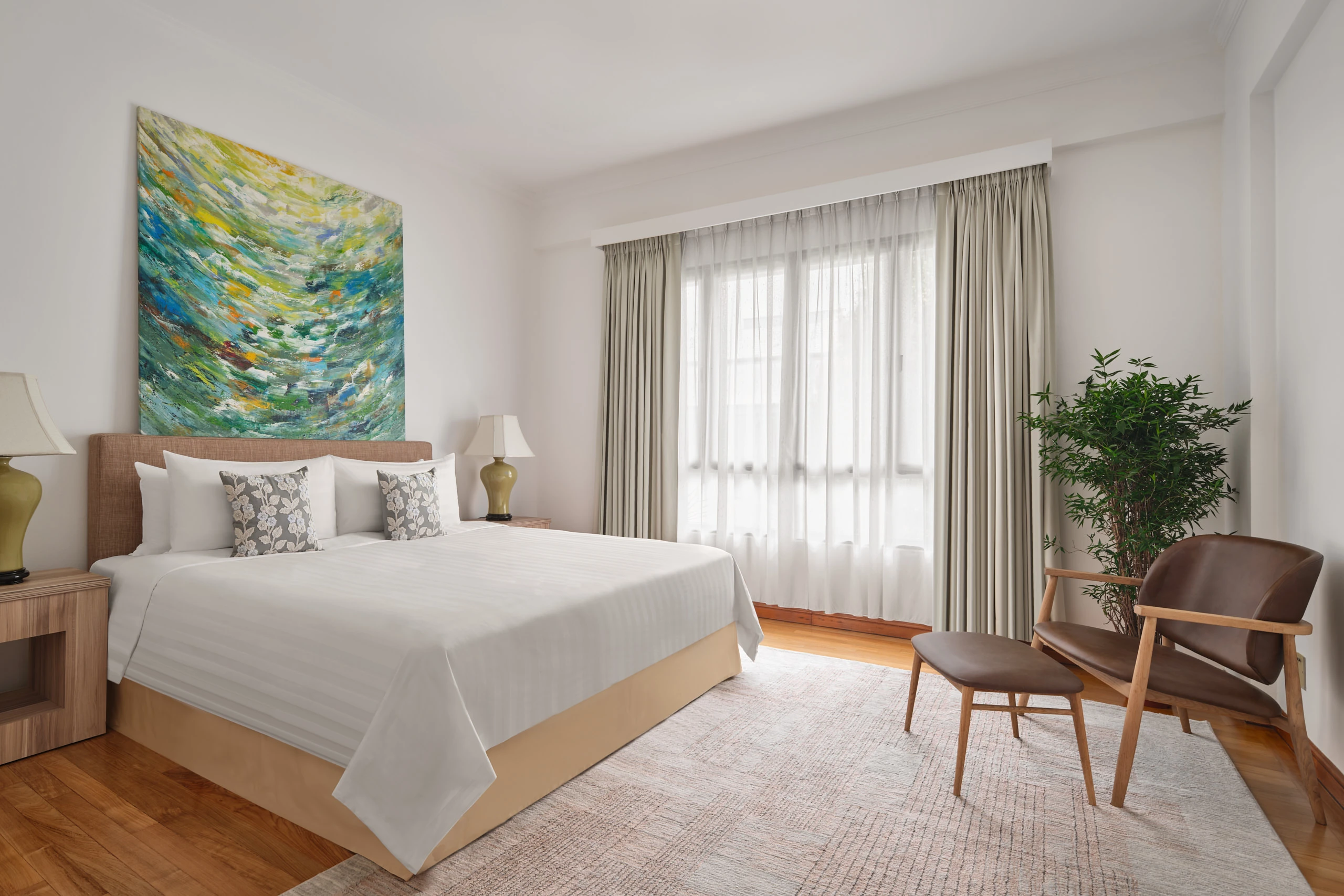 Master bedroom with king bed, abstract art and natural light, Shangri-La Residences Singapore
