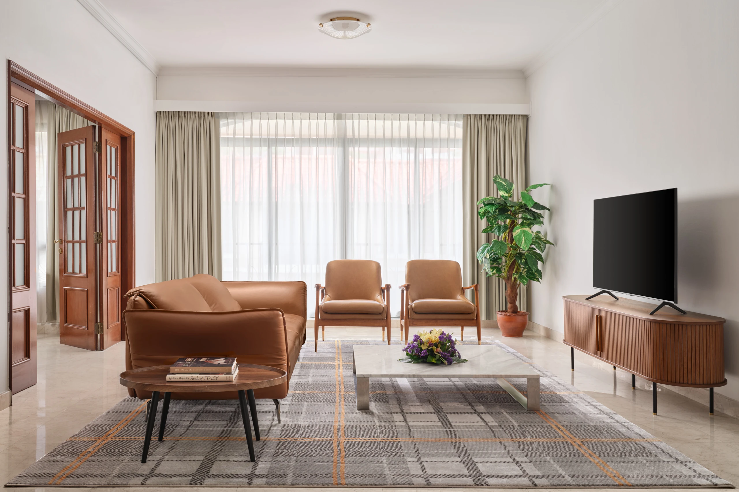 Spacious living room with leather sofa and armchairs, Shangri-La Residences Singapore