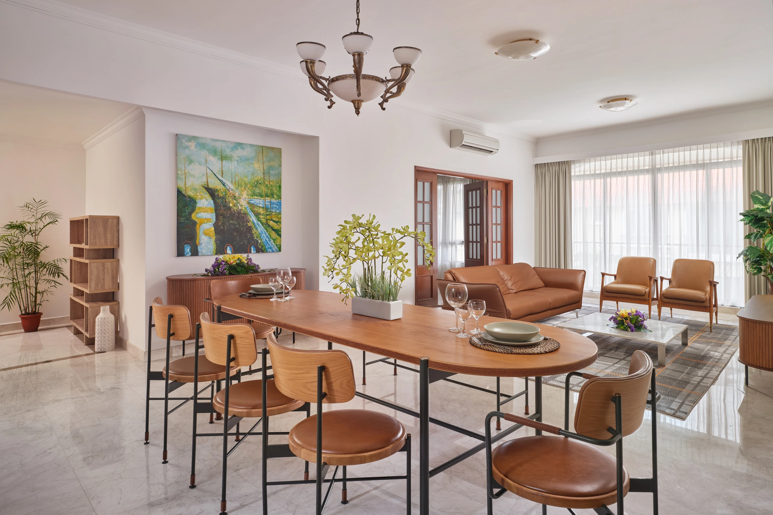 Open-plan dining and living area with wooden table and art, Shangri-La Residences Singapore