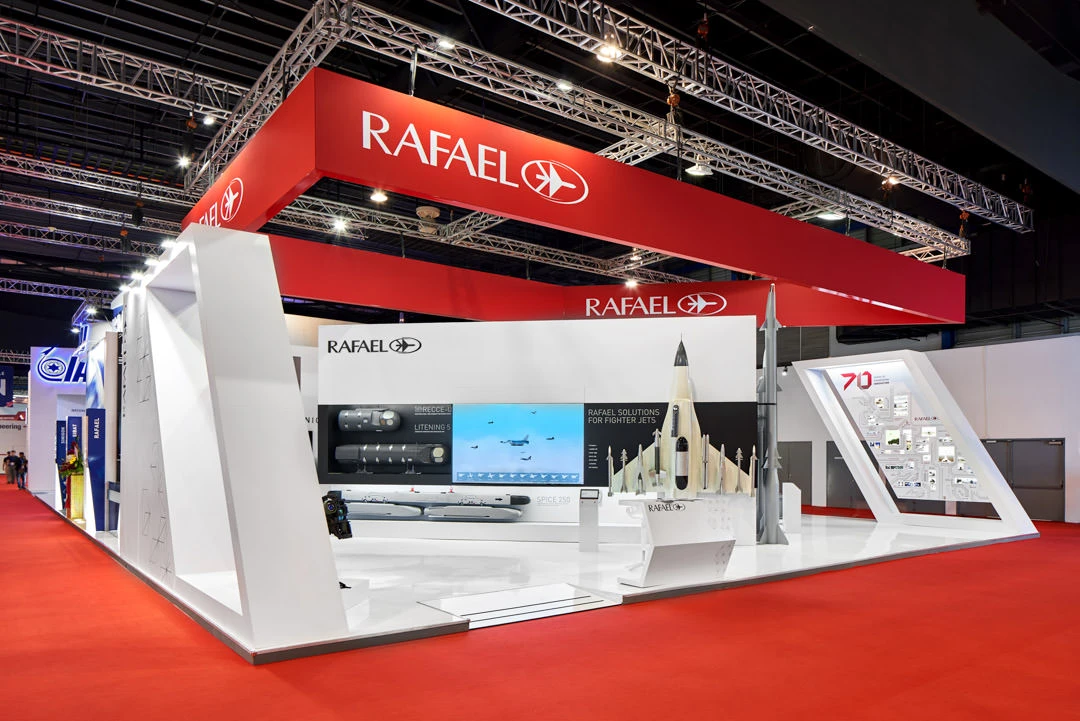 Rafael defence booth with red canopy, missile models and fighter jet display