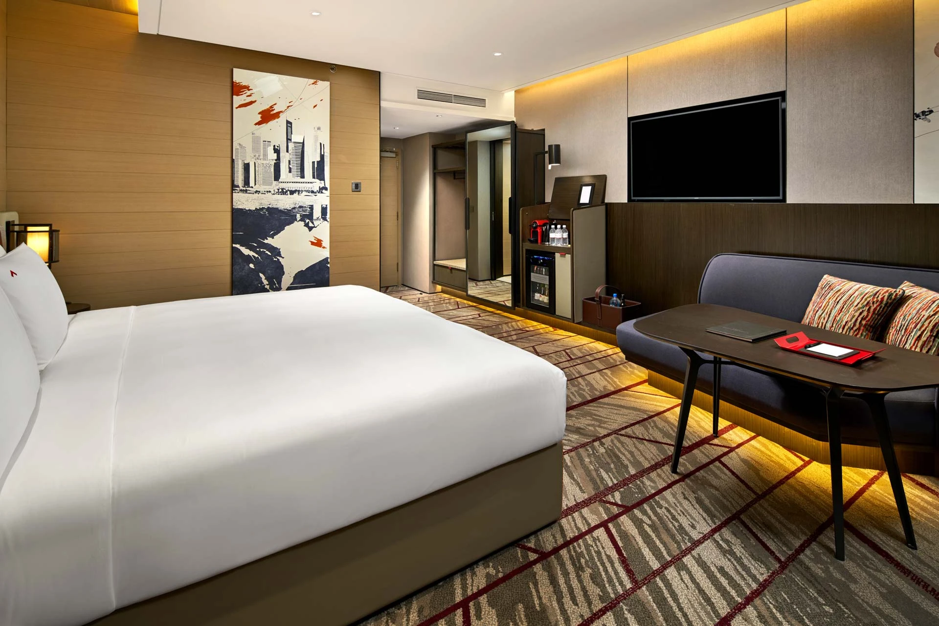 King room with Singapore cityscape art panel and minibar station — Swissotel The Stamford interior photography