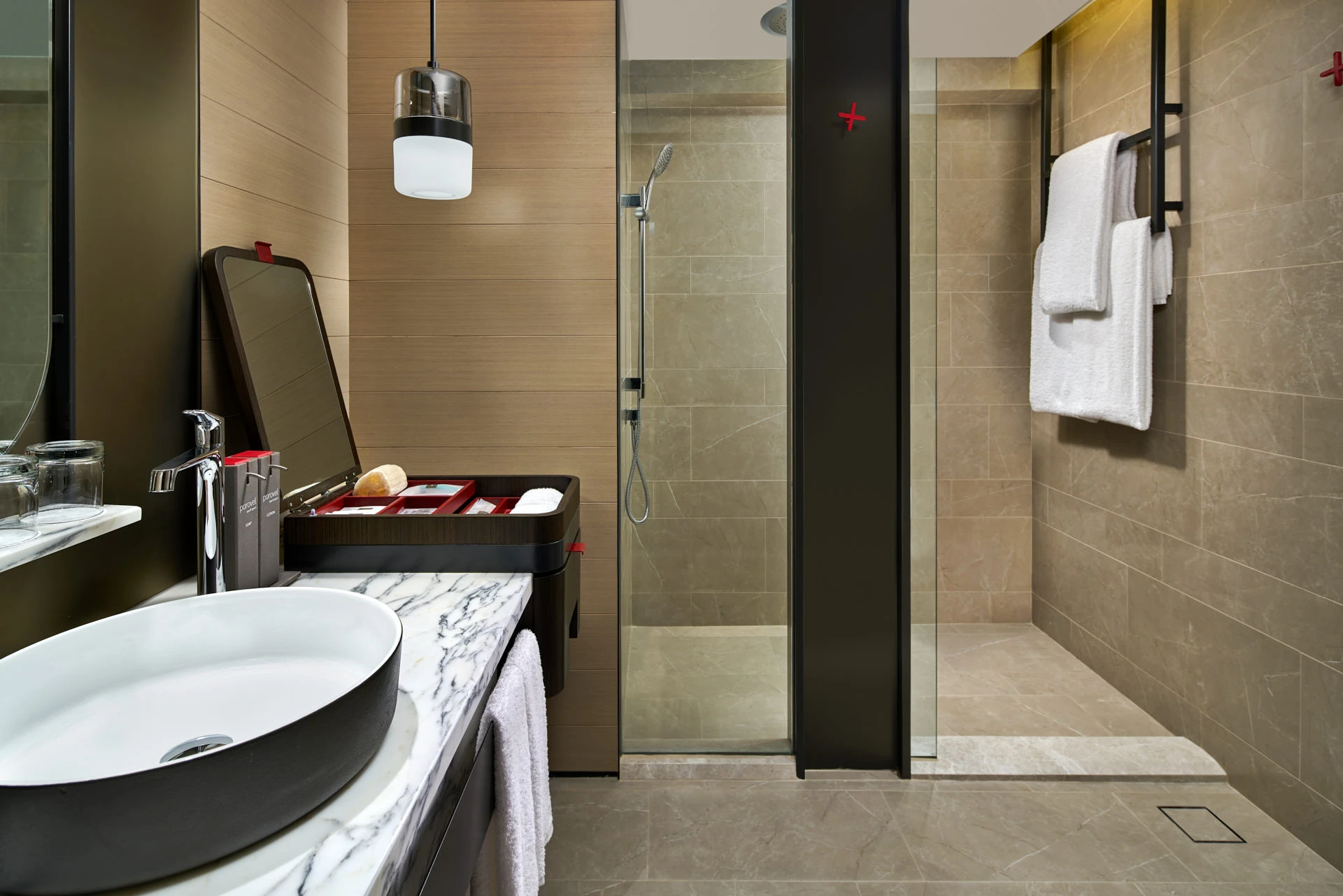 Bathroom with oval vessel sink, rain shower and pendant light — Swissotel The Stamford Singapore interior photography