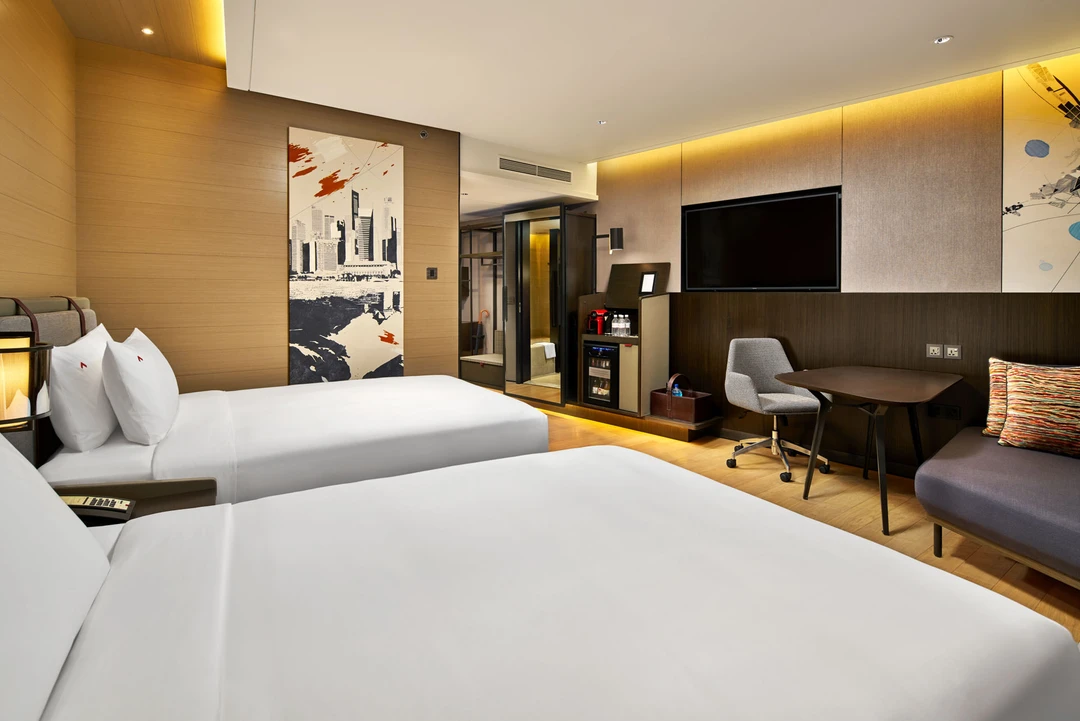 Twin room with cityscape mural, glass wardrobe and desk — Swissotel The Stamford Singapore hotel photography