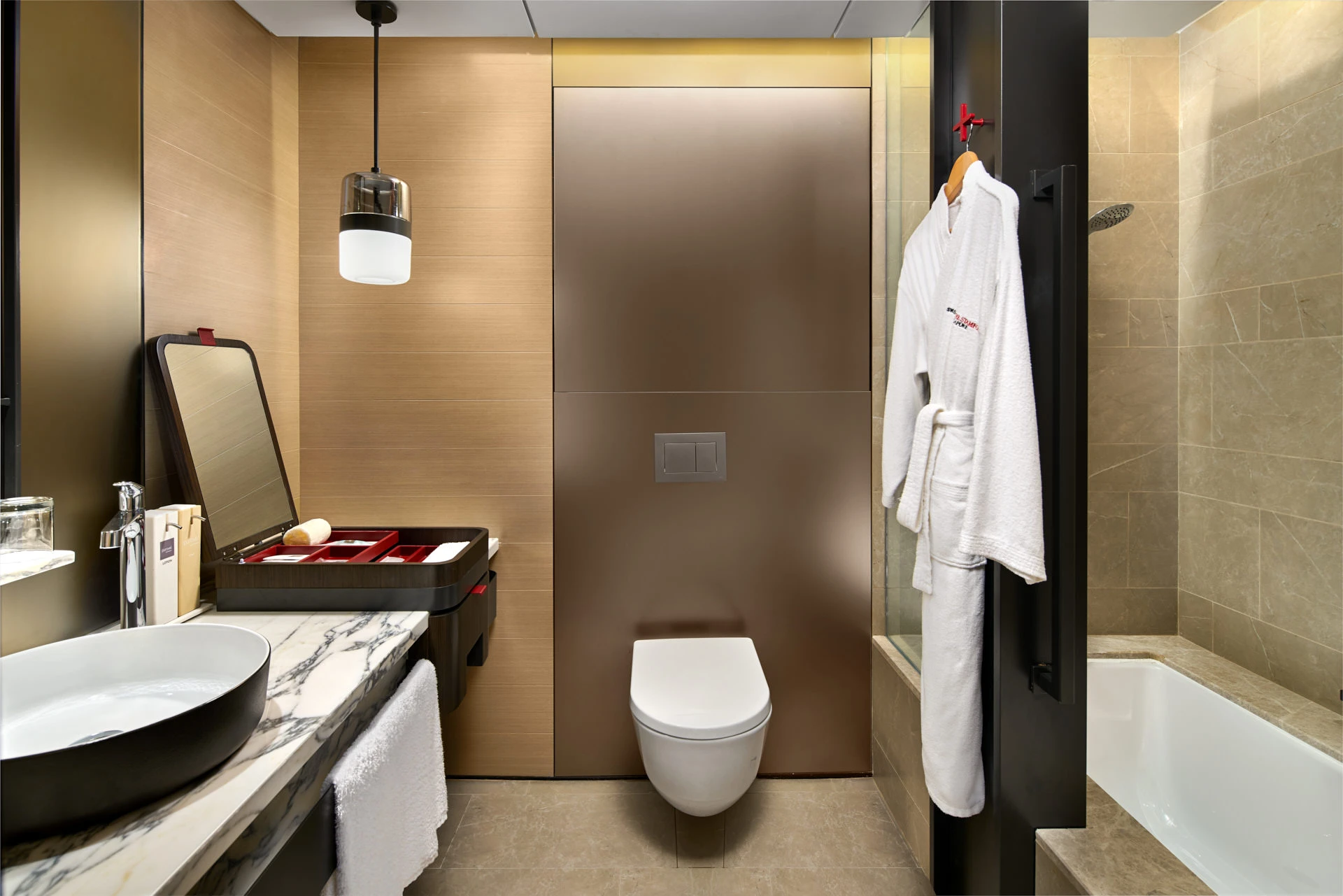Bathroom with vessel sink, marble vanity and copper accent panel — Swissotel The Stamford Singapore interior photography