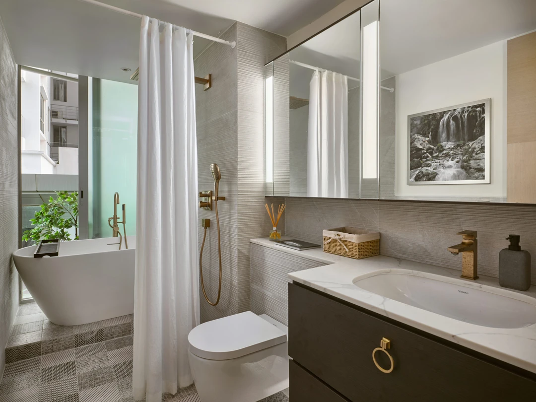 Spa bathroom with freestanding tub, marble vanity and geometric floor