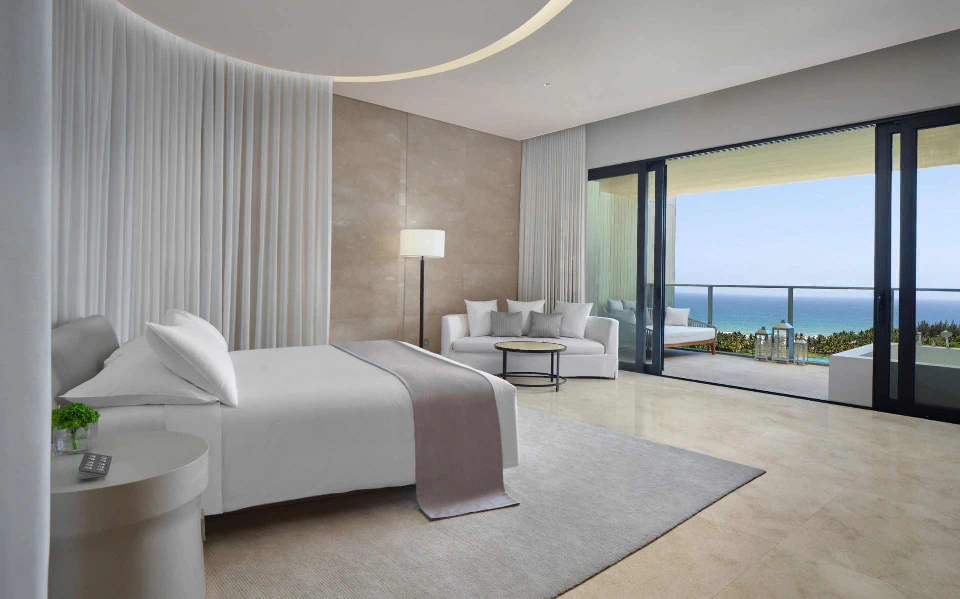 The Sanya EDITION loft room with oceanfront canopy draping and sea view balcony