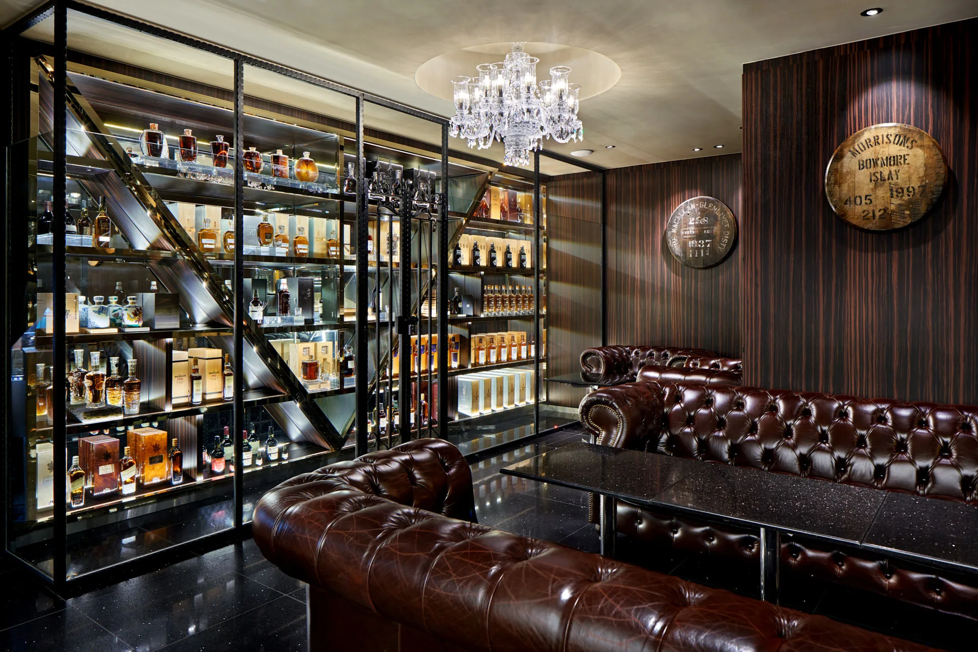 Private whiskey vault room with rare bottles and mounted cask ends