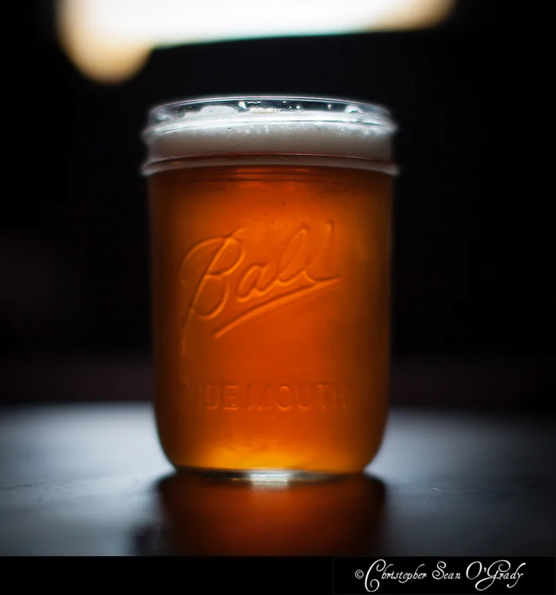 Craft beer in a Ball mason jar on a dark bar counter