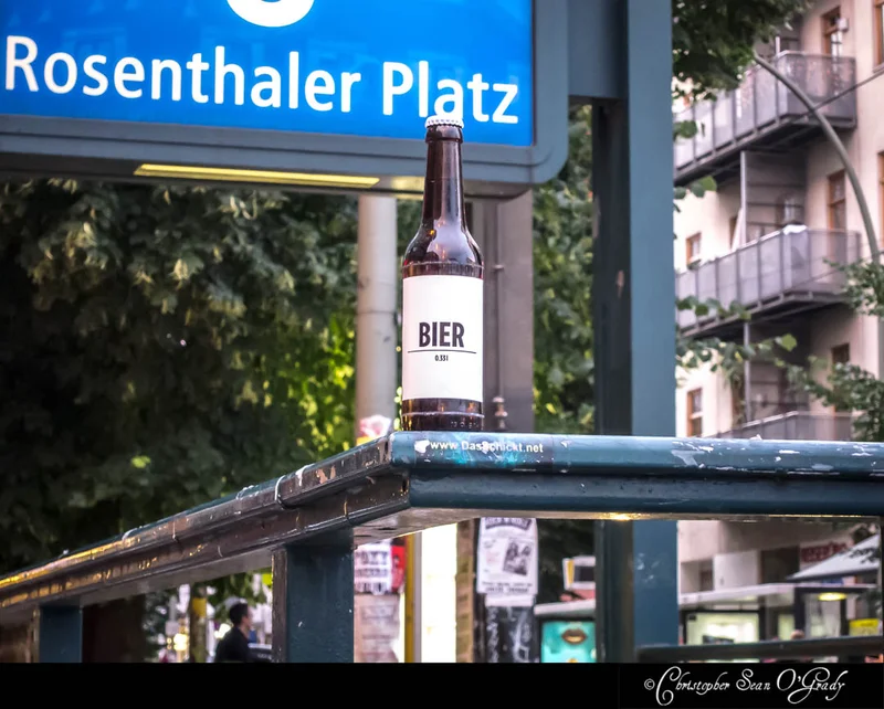 Das Schickt Bier on a railing at Berlin Rosenthaler Platz U-Bahn station