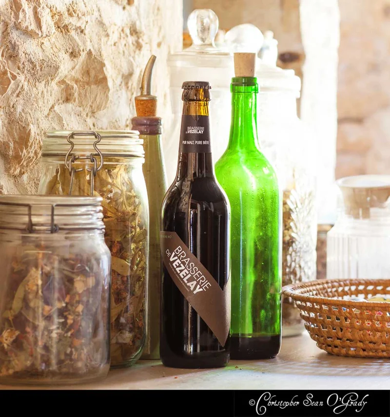 Brasserie de Vezelay beer on a rustic stone kitchen counter with jars