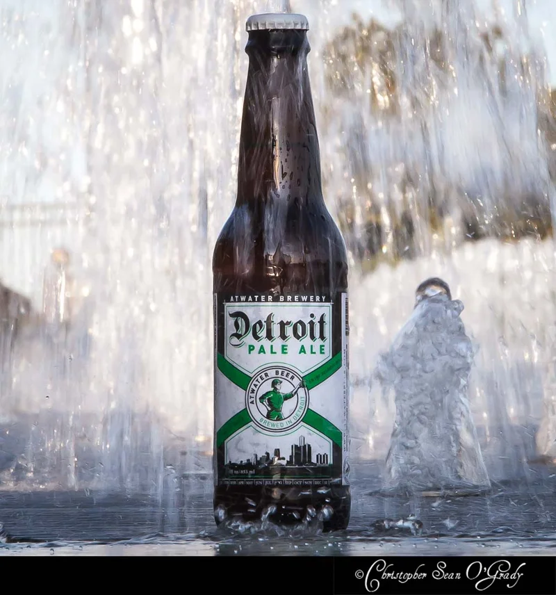 Atwater Brewery Detroit Pale Ale bottle with water fountain splashing behind