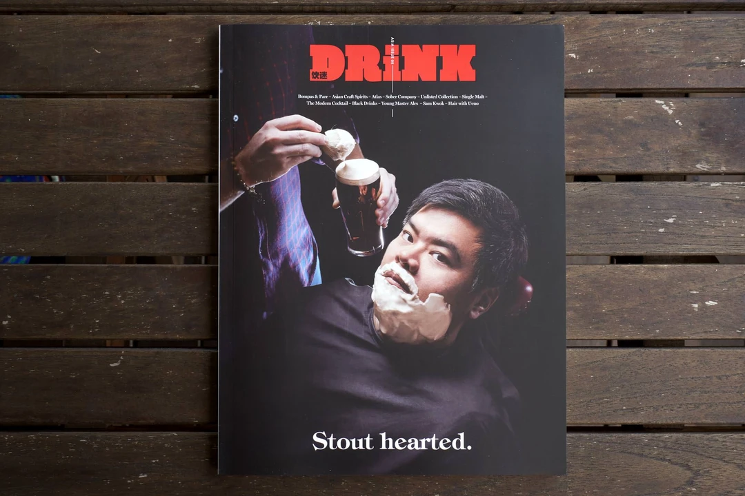 Drink Magazine issue 05 cover on wooden slats, featuring a man with shaving cream holding a stout glass, red masthead reading Stout Hearted.