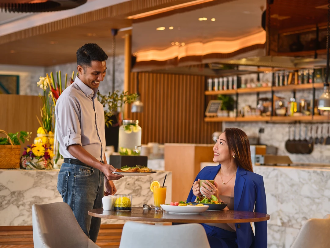Hilton Garden Inn Singapore Serangoon restaurant lifestyle photography with couple dining at breakfast