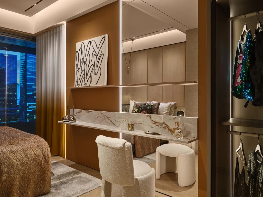 W Residences 5-bedroom showflat secondary bedroom with city view, dressing table and warm neutral finishes