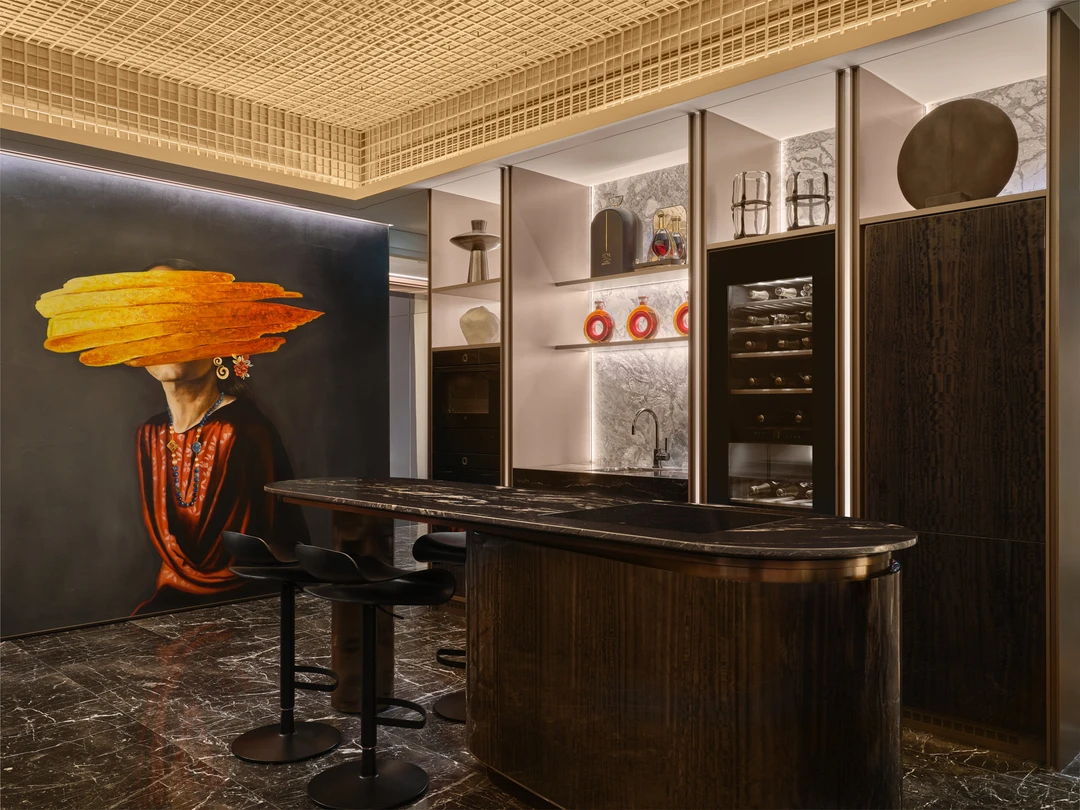 W Residences 5-bedroom showflat bar and dining area with dark stone island, artwork and display shelves