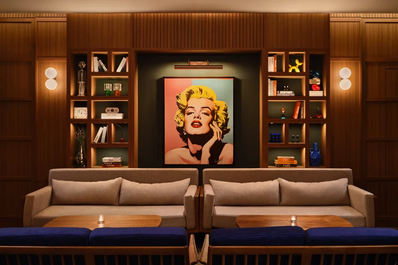 APT 101 Bangkok entertainment room lounge with sofas and statement art