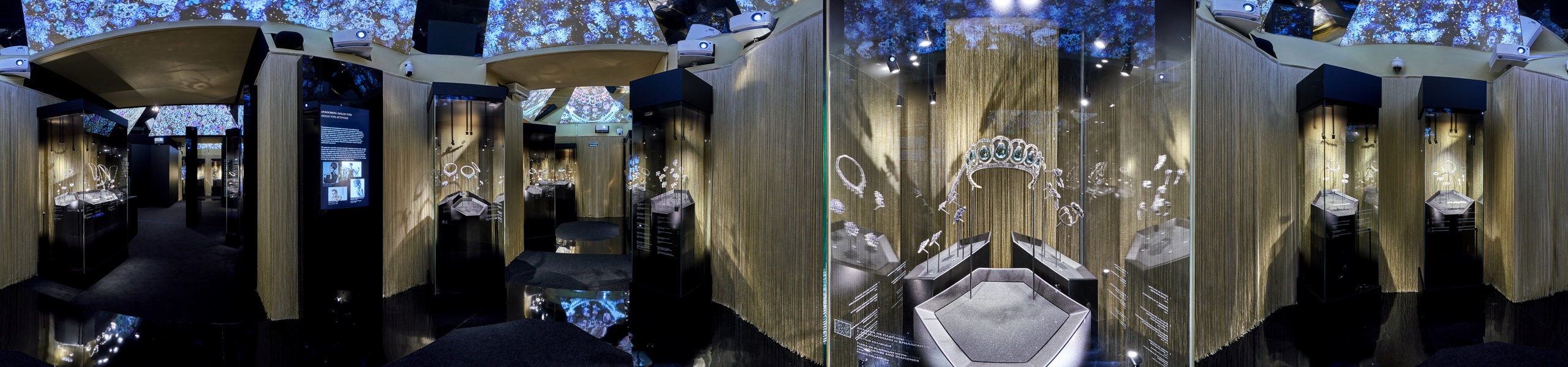 360 panorama of Bulgari Kremlin exhibition with jewellery vitrines, projected gemstone ceiling and tiara display behind glass