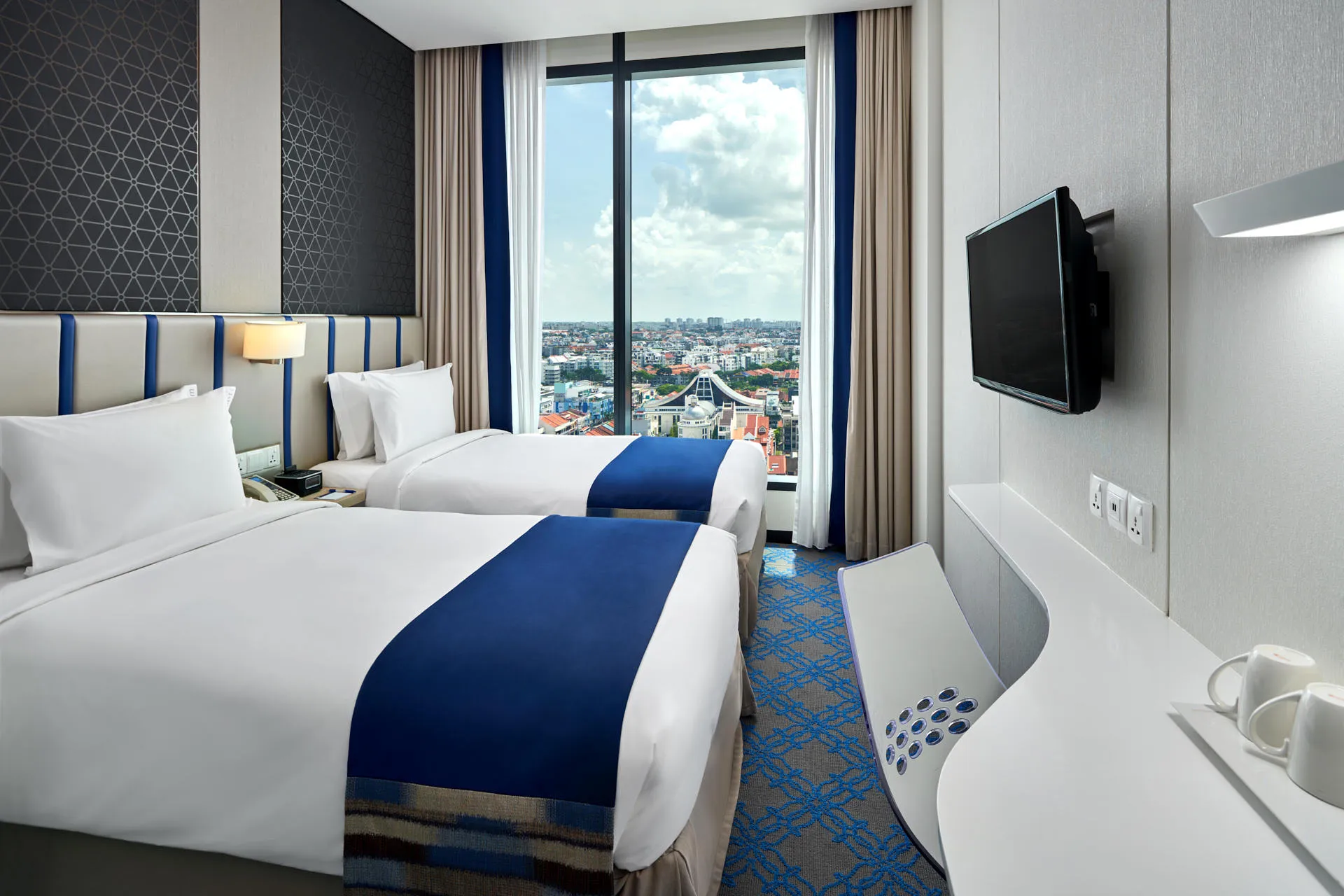Twin room with panoramic city view through floor-to-ceiling window — Holiday Inn Express Katong hotel photography