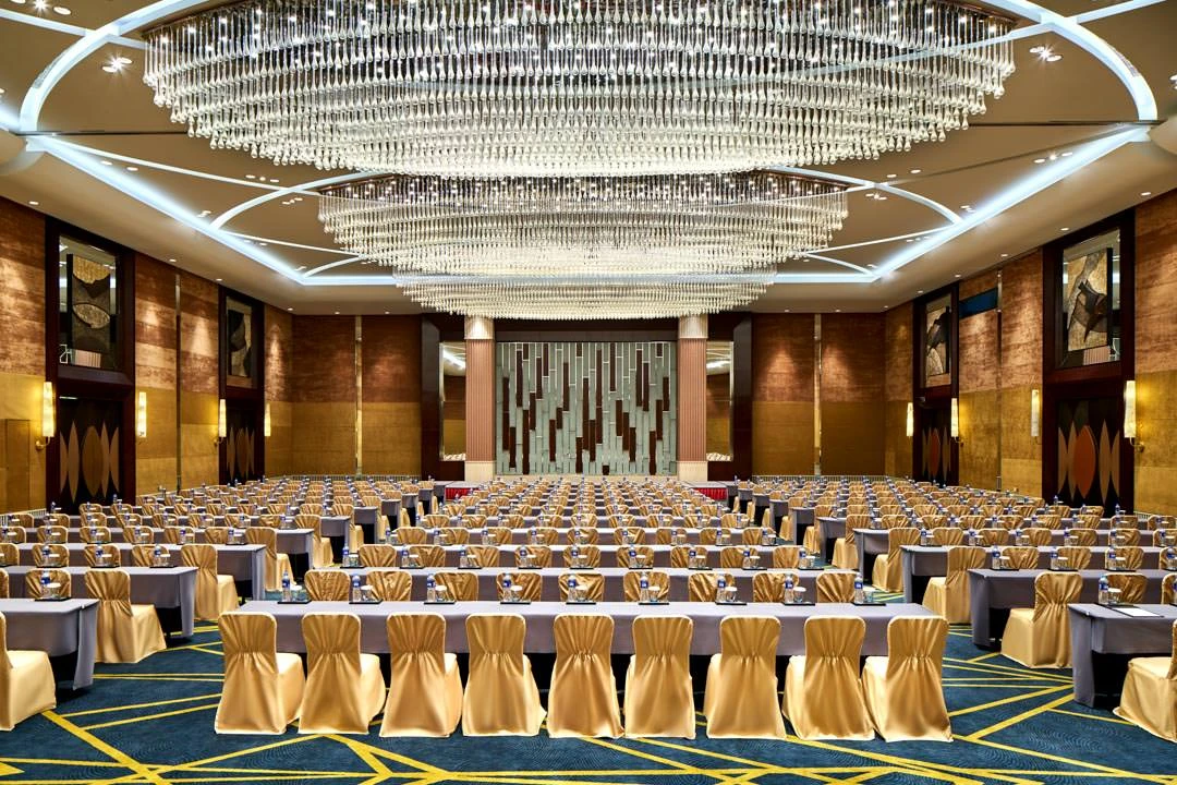 Grand ballroom classroom setup with crystal chandelier and gold chairs — Crowne Plaza Tianjin Binhai function room photography