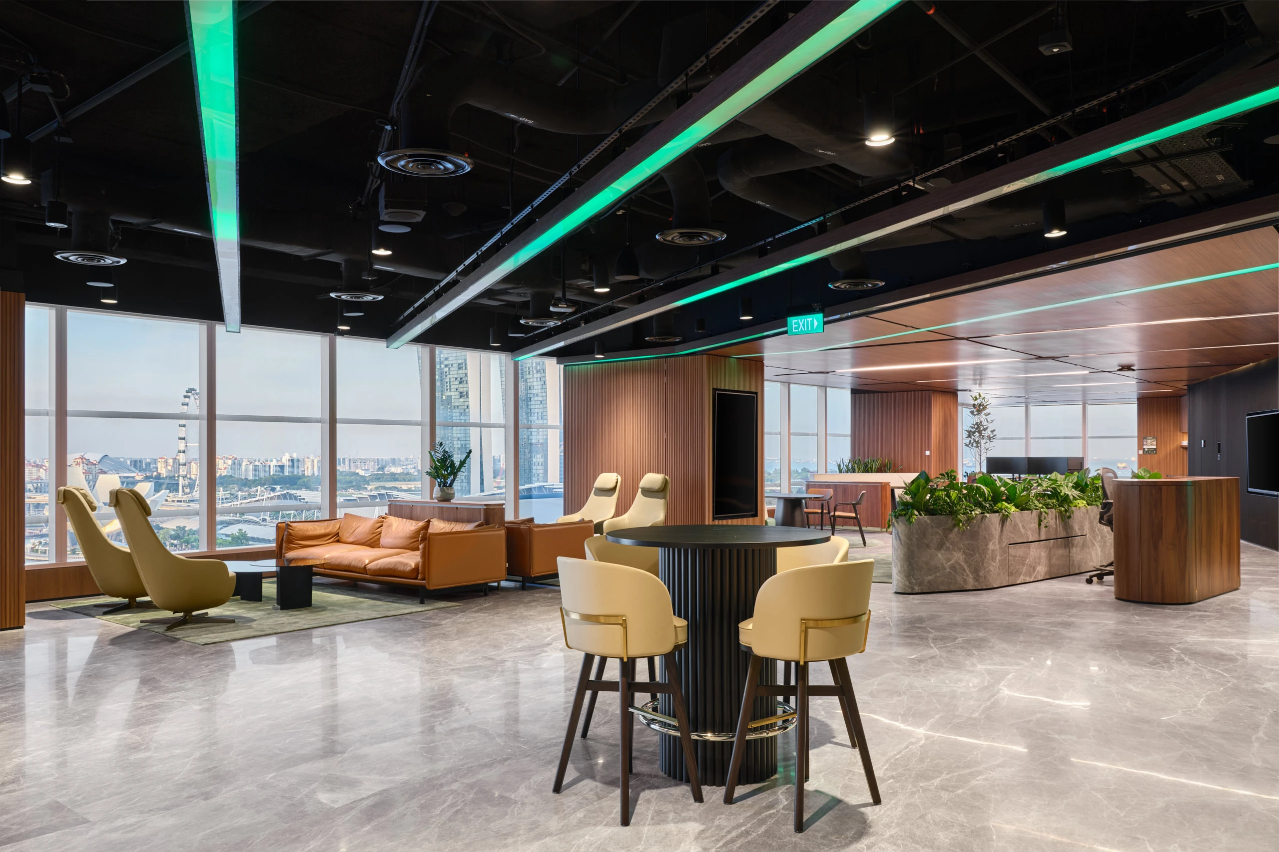 Collaboration lounge with green armchairs, timber ceiling and city views