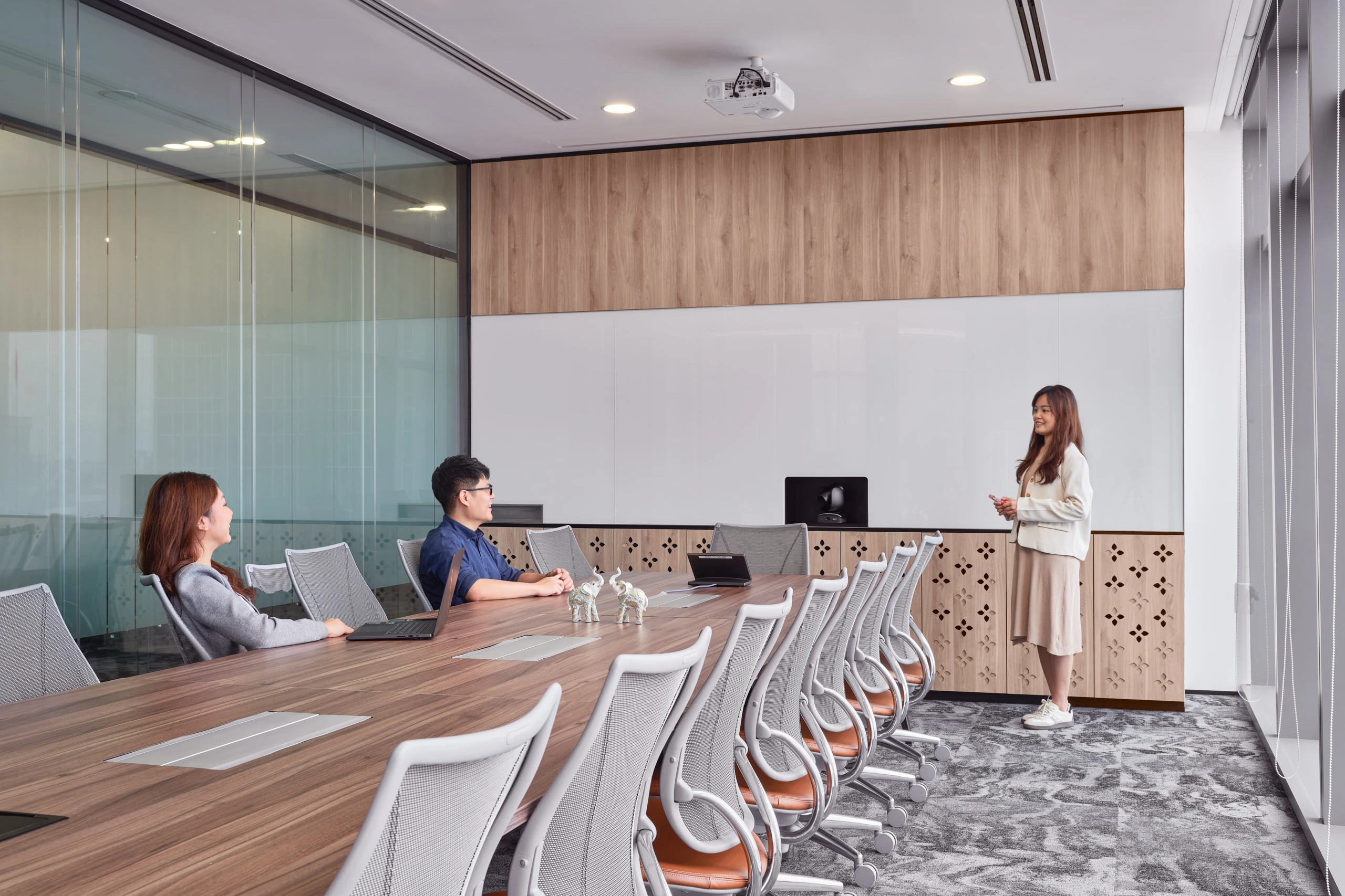 Formal boardroom with Peranakan laser-cut cabinetry and whiteboard wall