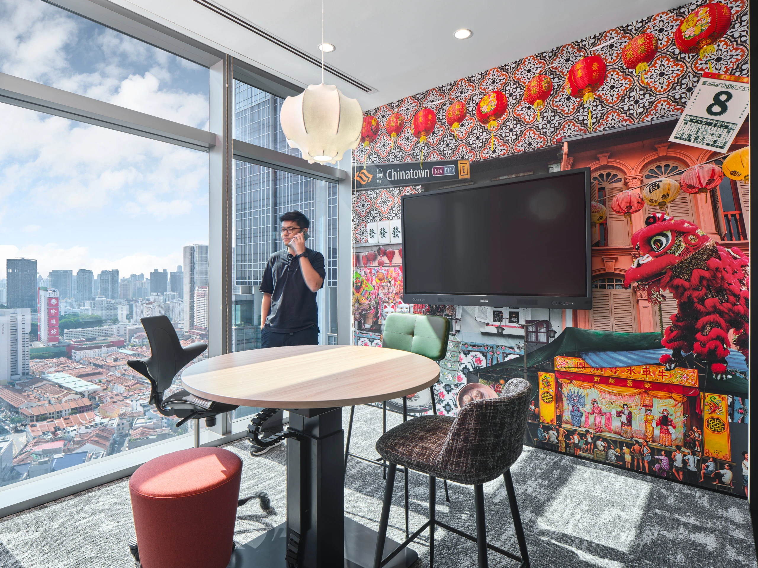 Chinatown-themed huddle room with photo mural and lotus pendant