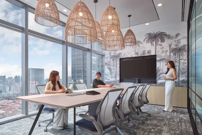 Boardroom with palm mural, rattan pendants and corner glazing
