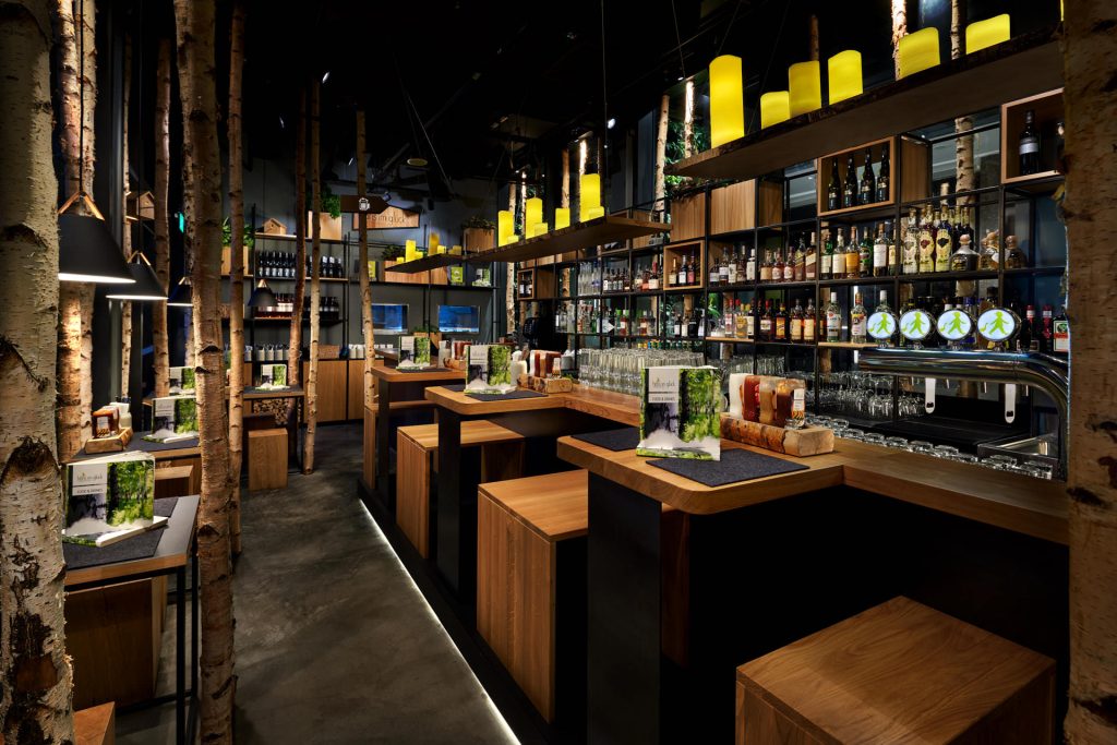 Dusk commercial restaurant photography of Hans Im Gluck in Singapore, designed by WOLF. The exterior shot highlights the glowing, warm interior and inviting ambiance at night.